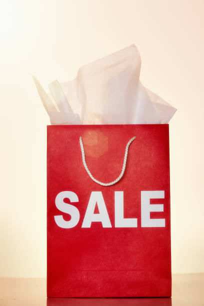 istock SALE label on bright red shopping bag 1015284814