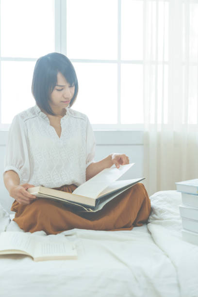 istock the 20s girl reading book. 1015284840