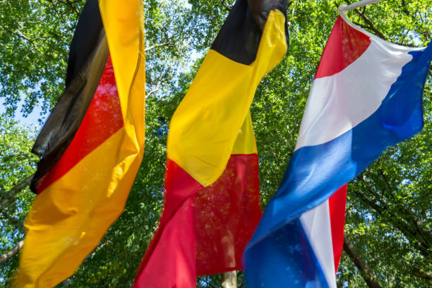 German-Dutch-Belgian border at tri-border region in Aachen Germany with waggling flags German-Belgian-Dutch border at the tri-border region in Aachen and Vaals with waggling flags of these countries as background aachen photos stock pictures, royalty-free photos & images