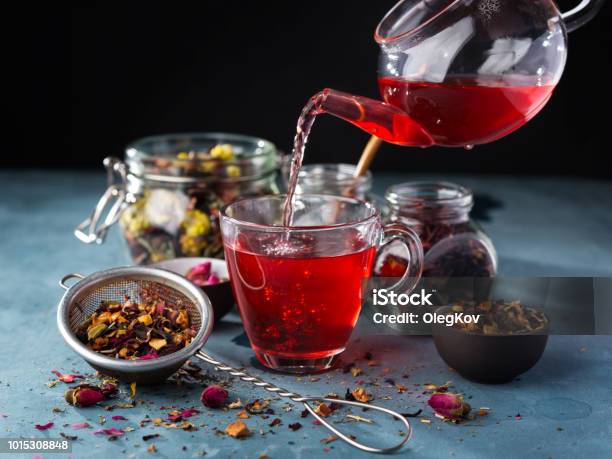 Process Brewing Tea Tea Ceremony Cup Of Freshly Brewed Fruit And Herbal Tea Dark Mood Hot Water Is Poured From The Kettle Into A Cup With Tea Leaves Stock Photo - Download Image Now