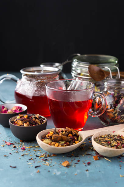istock Fresh fruit and herbal tea ,dry leafs  with rose petals. Summer refreshing drink. Dark mood. 1015309746
