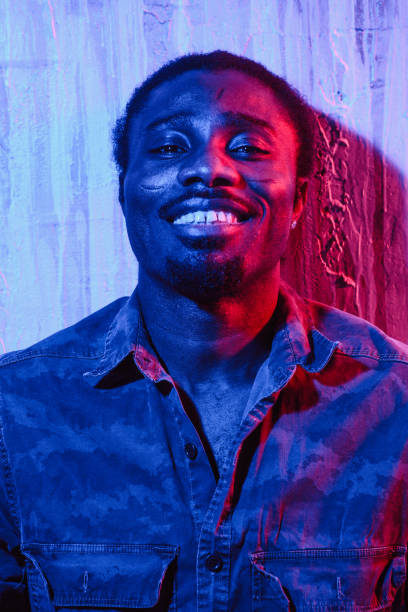 istock Ethnic man leaning to wall and smiling 1015314874