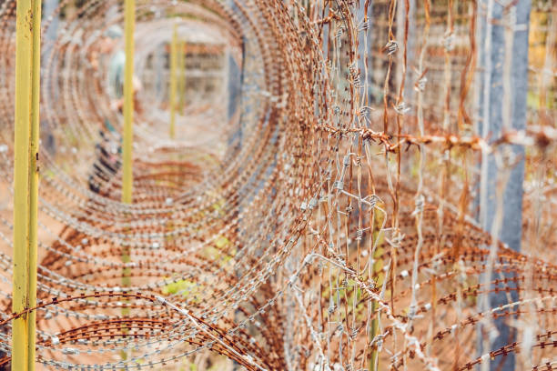 istock Barbed wire, a fence in prison. Prison concept. 1015315586