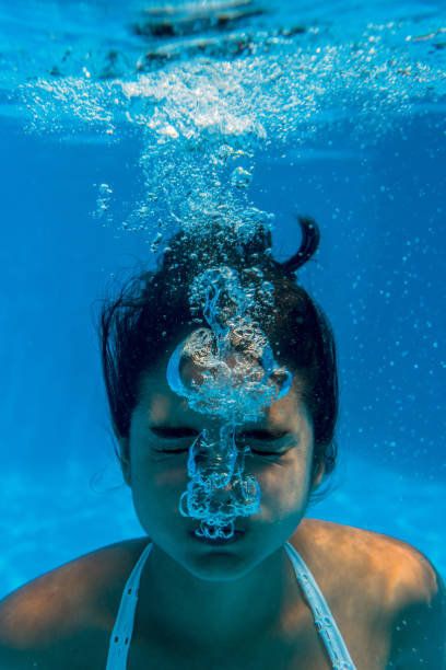istock Girl underwater in a swimming pool 1015315784
