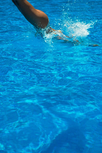 istock Girl diving into a swimming pool 1015320018