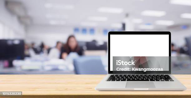 Laptop With Blank Screen On Desk Table With Blur Office Interior Background Stock Photo - Download Image Now