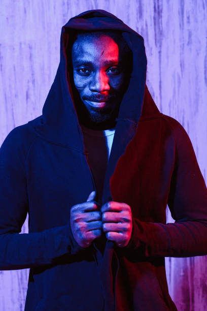 istock Man in hoodie on neon light 1015320296