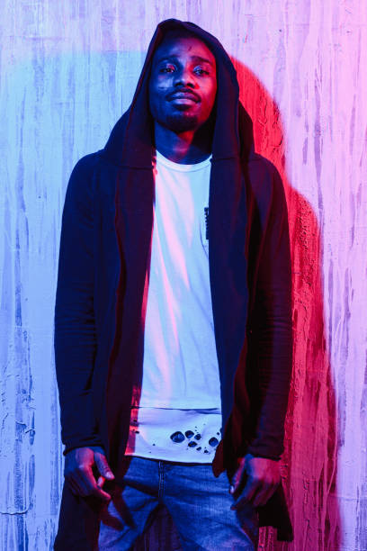 istock Man posing in hoodie on neon light 1015320656