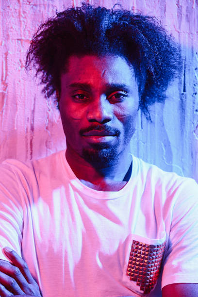 istock Ethnic man with long hair on neon light 1015321086