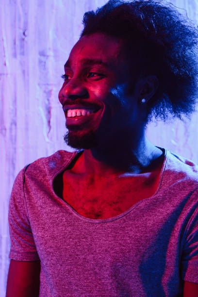 istock Man with long hair on neon lighting 1015321216