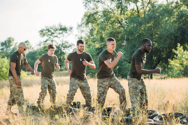 istock side view of interracial soldiers practicing with tires on ground on range 1015321322