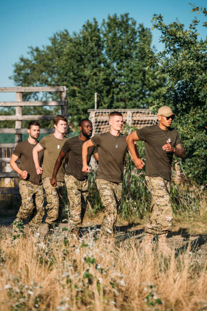 istock multiethnic soldiers in military uniform running on range 1015323964