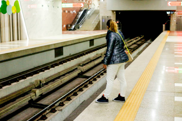 istock Young woman waiting for subway train 1015324014