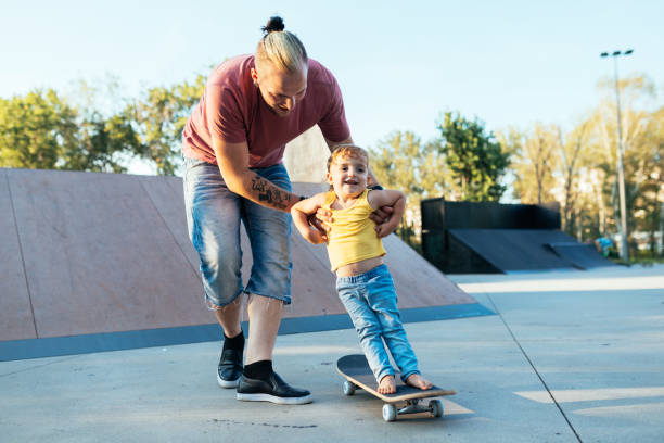 istock Three year old son with dad in skate park 1015326712