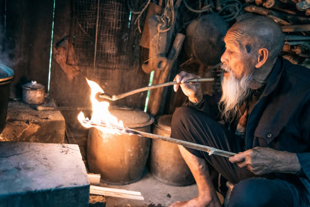 istock old chinese senior man lighting smoking pipe 1015327410