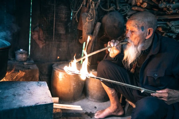 istock old chinese senior man lighting smoking pipe 1015327516