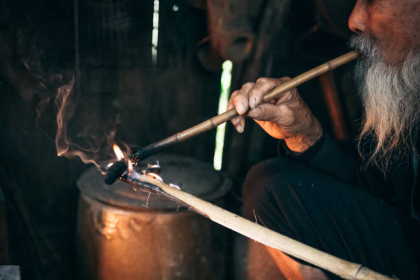 istock old chinese senior man lighting smoking pipe 1015327600