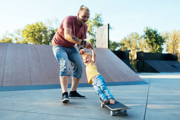 istock Three year old son with father in skate park 1015327834