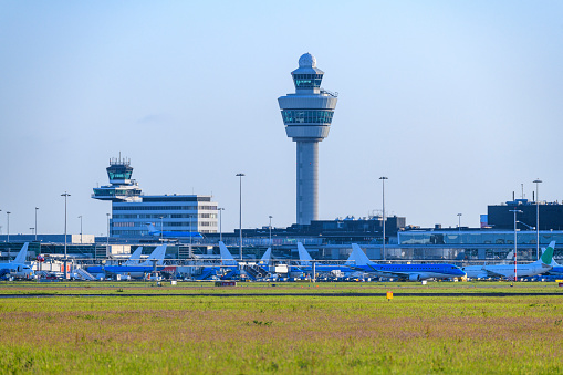 Airplanes at Amsterdam Schiphol Airport in The Netherlands during a springtime sunset.