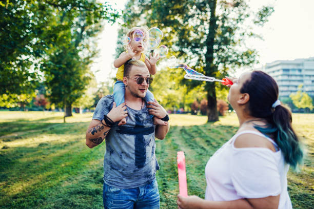 istock Mom and dad with three year old son in park 1015345232