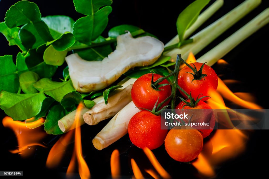 Burning Thai Tom Yam herbs and spices on black background Asian Food Stock Photo