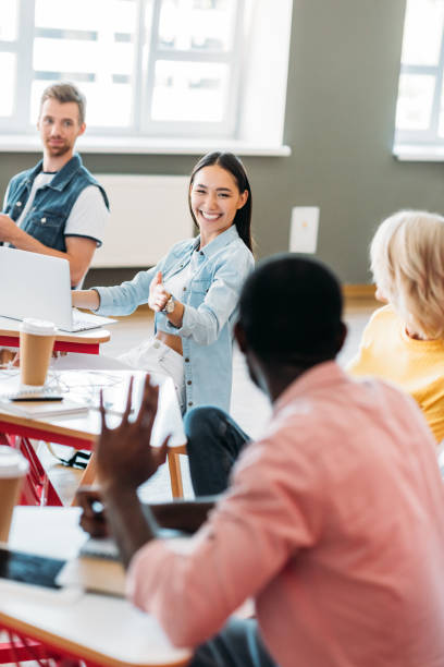 istock happy young students chatting at classroom of college 1015346268