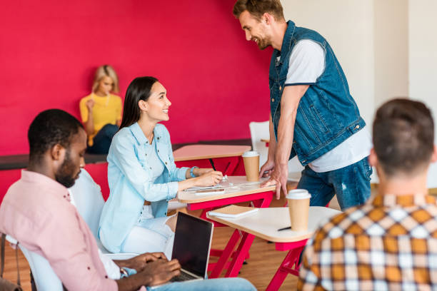 istock smiling young students studying together at college 1015350468