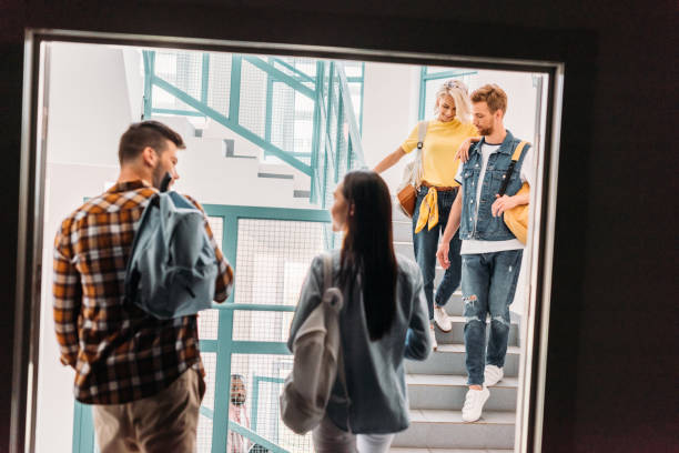 istock happy young students walking on stairs at college 1015350692