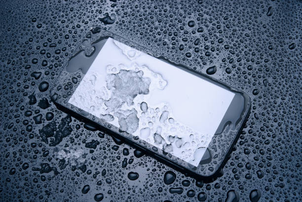 istock Smartphone covered with water and wet snow. 1015354002