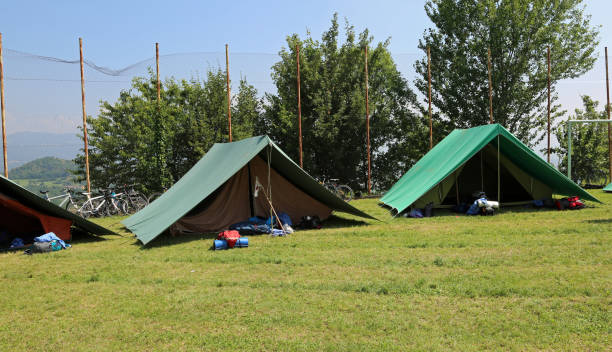istock two green tents mounted by scouts in a meadow 1015354386