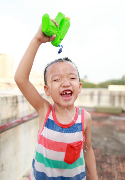 istock Children playing with squirt gun 1015361724