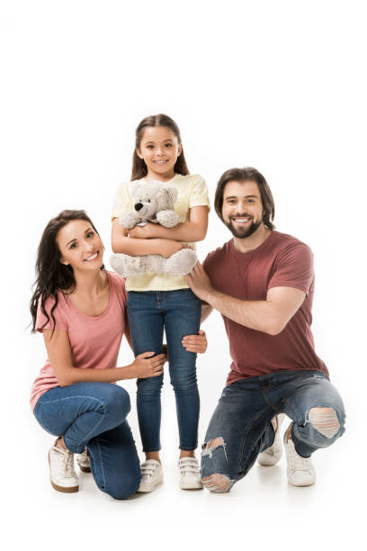 istock smiling parents and daughter with teddy bear isolated on white 1015371434