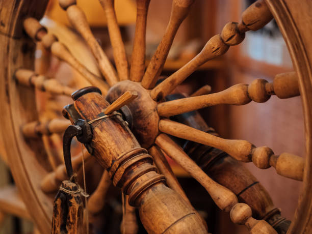 istock Old antique wooden spinning wheel, close up 1015375026
