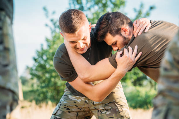 istock selective focus of young soldiers practicing hand to hand fighting on range 1015375286