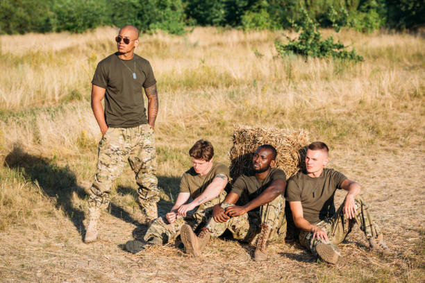istock multiracial young soldiers in military uniform resting on range 1015375302