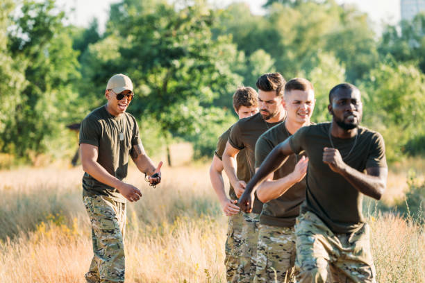 istock african american tactical instructor with stop watch examining multiracial soldiers during obstacle run on range 1015375304