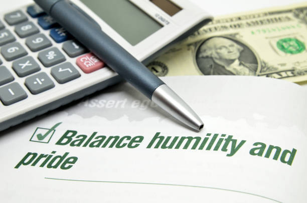 istock Balance humility and pride printed on book 1015378086