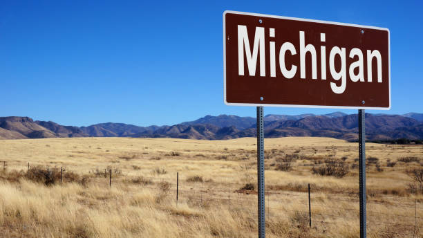 istock Michigan road sign with blue sky 1015378264