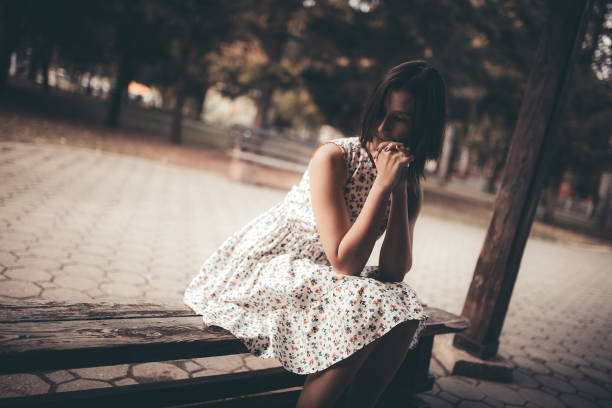 istock Caucasian girl sitting on a bench 1015379208