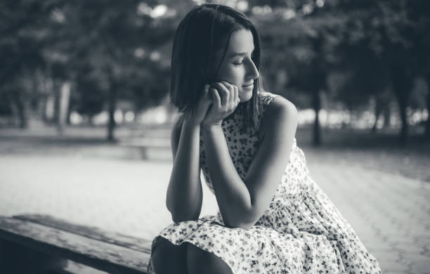 istock Caucasian girl sitting on a bench 1015387140