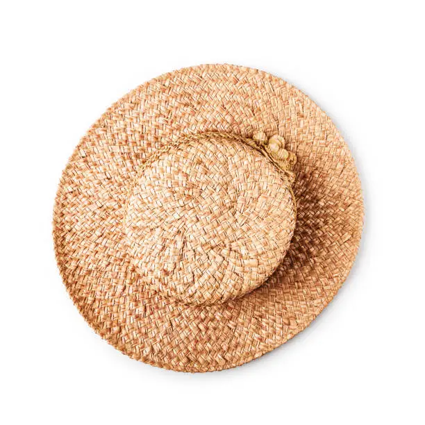 Straw hat with flower isolated on white background, single object with clipping path. Summer fashion woman. Flat lay, top view