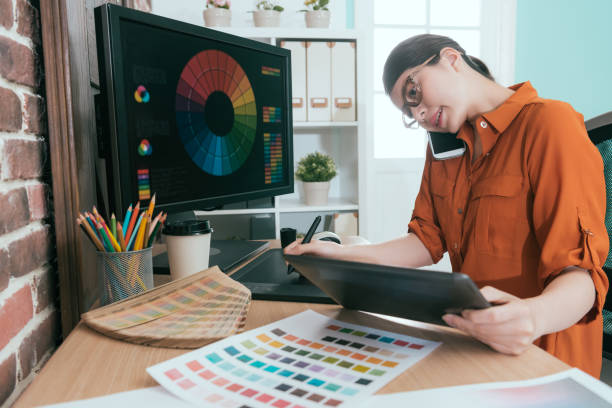 istock happy pretty woman designer talking with customer 1015393260