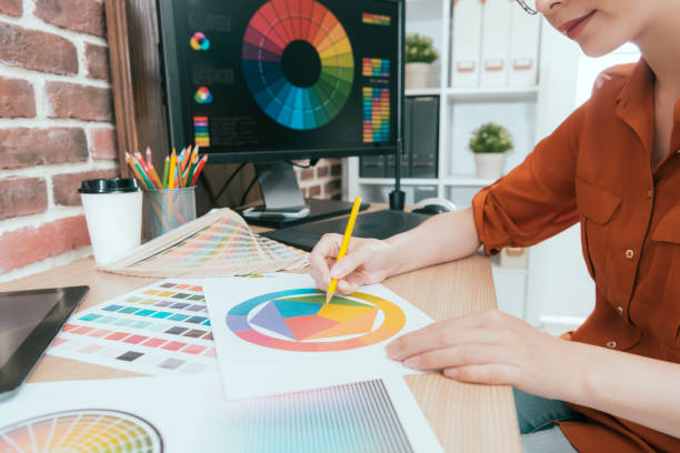 istock woman designer looking at palette chart paper 1015393506