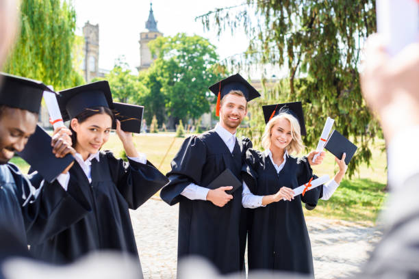 istock young graduated students spending time together in college garden 1015393868