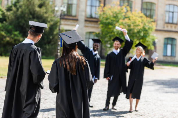 istock young graduated students having fun in university garden 1015393906