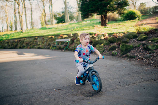istock Young Boy Riding his Bicycle Through the Park 1015394022