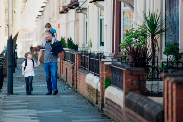 Mid Adult Man Walking with his Sons