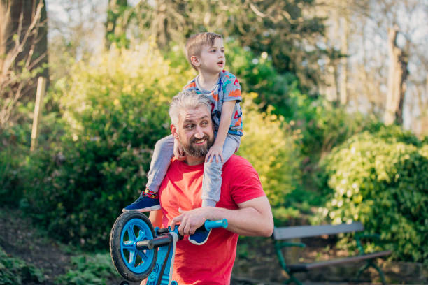 istock Carrying his Son on his Shoulders in the Park 1015399054