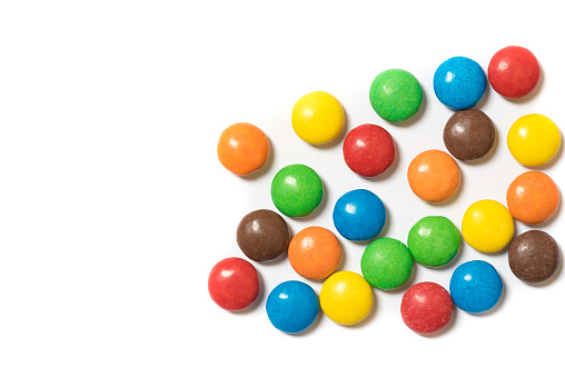 Sugar-coated coloured chocolate candies on white background
