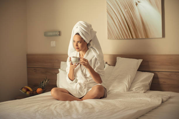 istock Young woman on bed wrapped in towel 1015404826